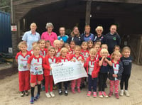 Rainbows present fundraising pot of gold to Erme Valley RDA