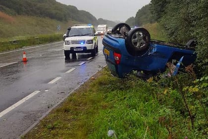 Car ends up on roof in heavy rain on A38
