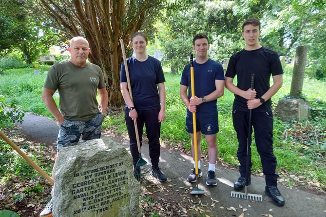 Warrant Officer Nick Trantham Royal Marines, and Officer Cadets Stephanie Winter, Callum Jarvis, and Ed Wanders next to two of the cleared graves. Photo Britannia Royal Naval College
