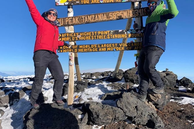 Sophie. and Lawrence Weeks reach the summit of Mount Kilimanjaro