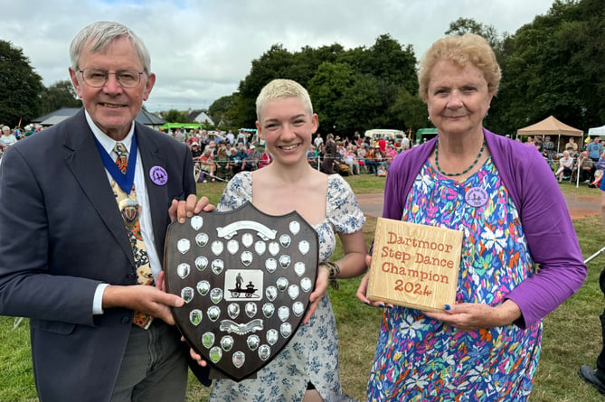 Alice Knight, centre, the 2024 Dartmoor Step Dance winner receives her trophies from the Deputy Mayor of West Devon, Cllr Paul Vachon, and right, President Shirley Bazeley.
