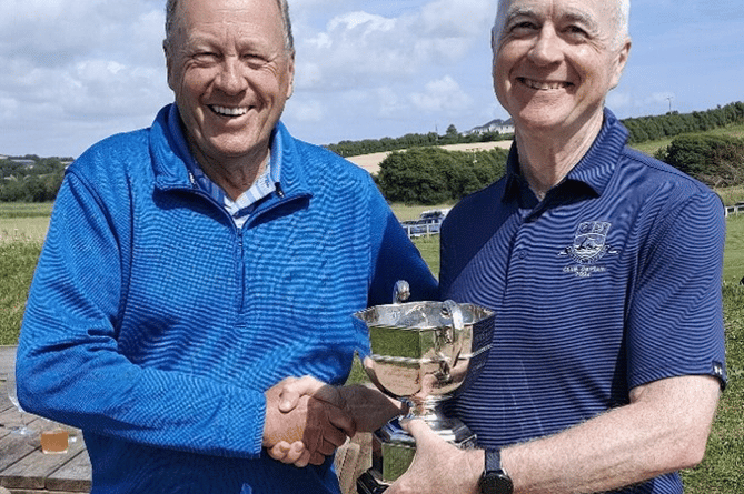 Don Thompson (left) is presented with the Allcomers Cup by Thurlestone club captain Jim Stewart