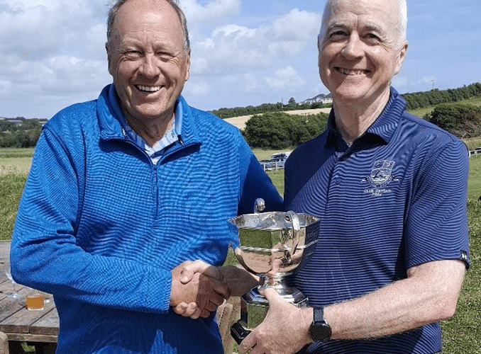 Don Thompson (left) is presented with the Allcomers Cup by Thurlestone club captain Jim Stewart