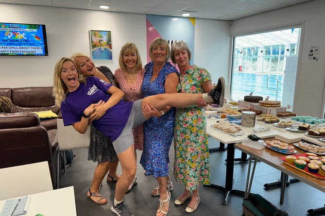 Ms Chapman being carried by some of her fundraising team members at a recent coffee morning at the Ivybridge Leisure Centre