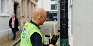 Neil paints bollard protecting special building in Totnes