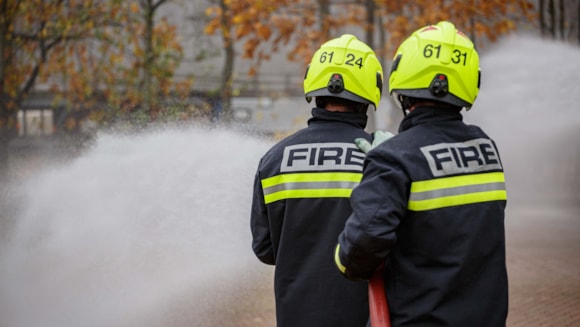 Firefighters using hose