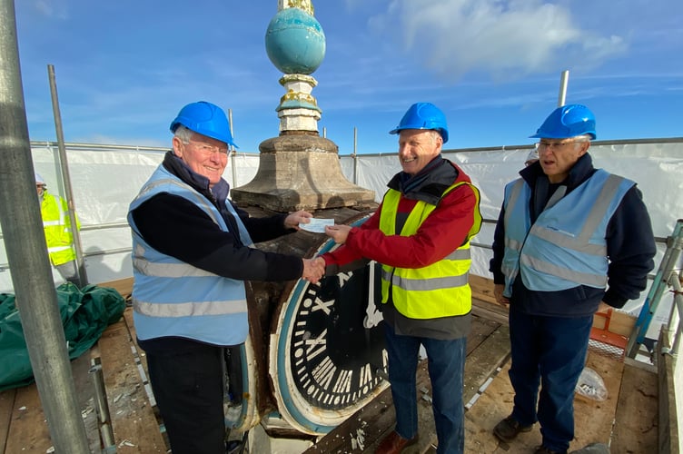 Jeremy Wilks presenting John Donovan with a cheque from the Freemasons