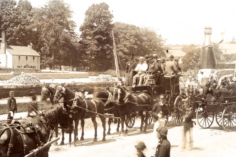 Coach and four, other horse drawn vehicles in a carnival procession, Quay, Kingsbridge.  A float with a huge champagne bottle.  Possibly Jubilee celebrations of 1897.