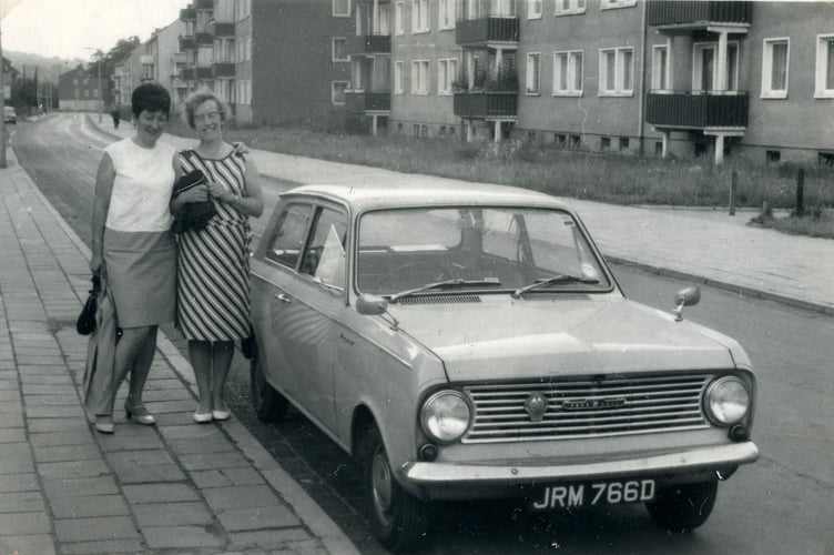 Two ladies standing by a Vauxhall Viva