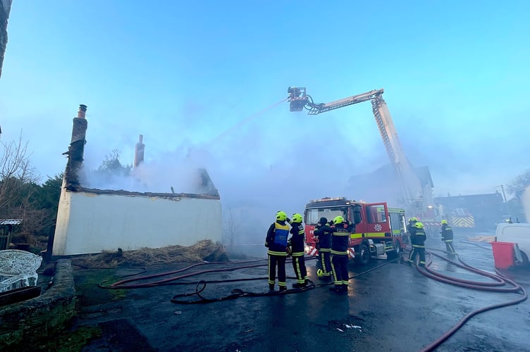 Firecrews at the scene of the thatched property fire in Drewsteignton.  Photo:  The Drewe Arms Community Pub/Facebook